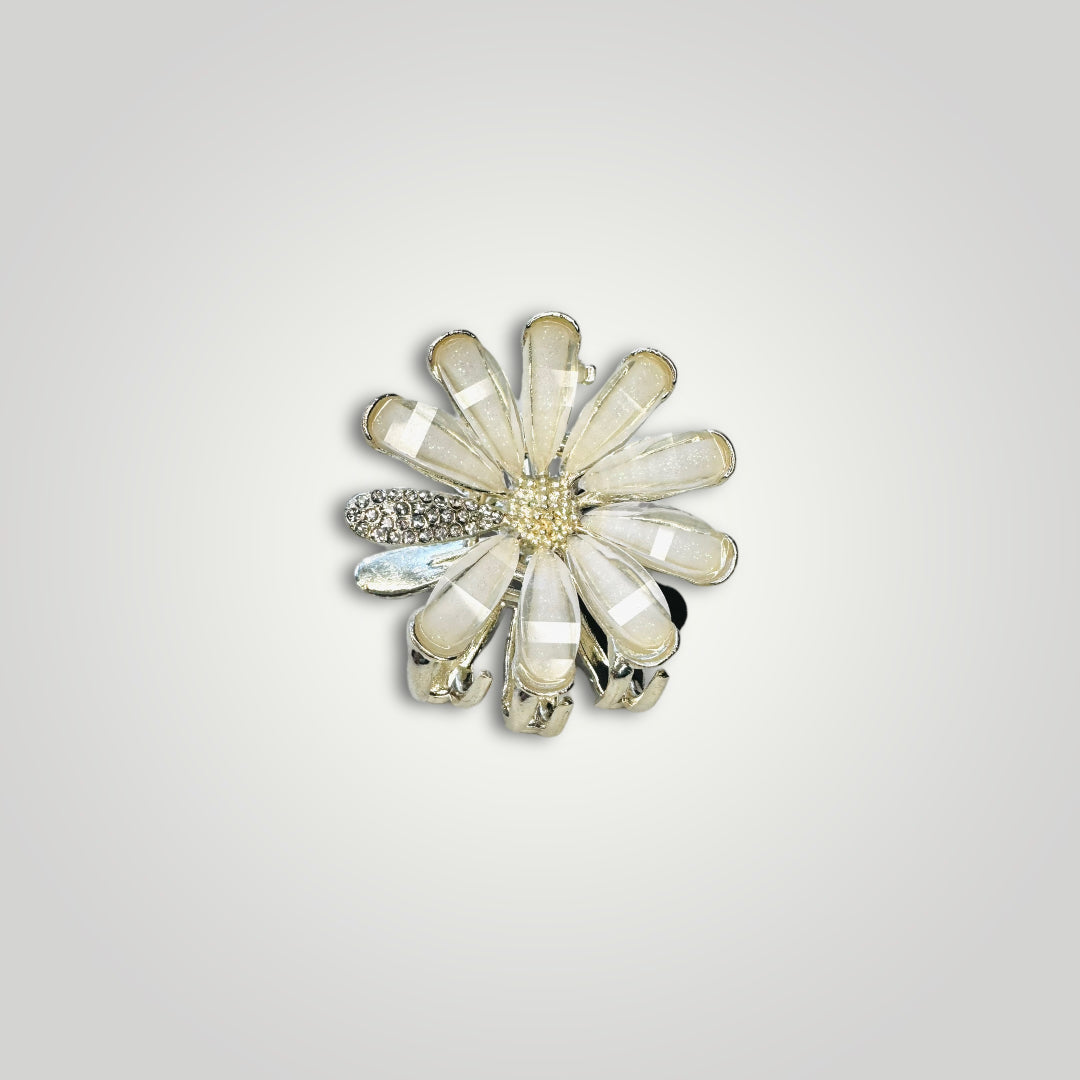 A golden metallic flower claw clip with crystal petals.