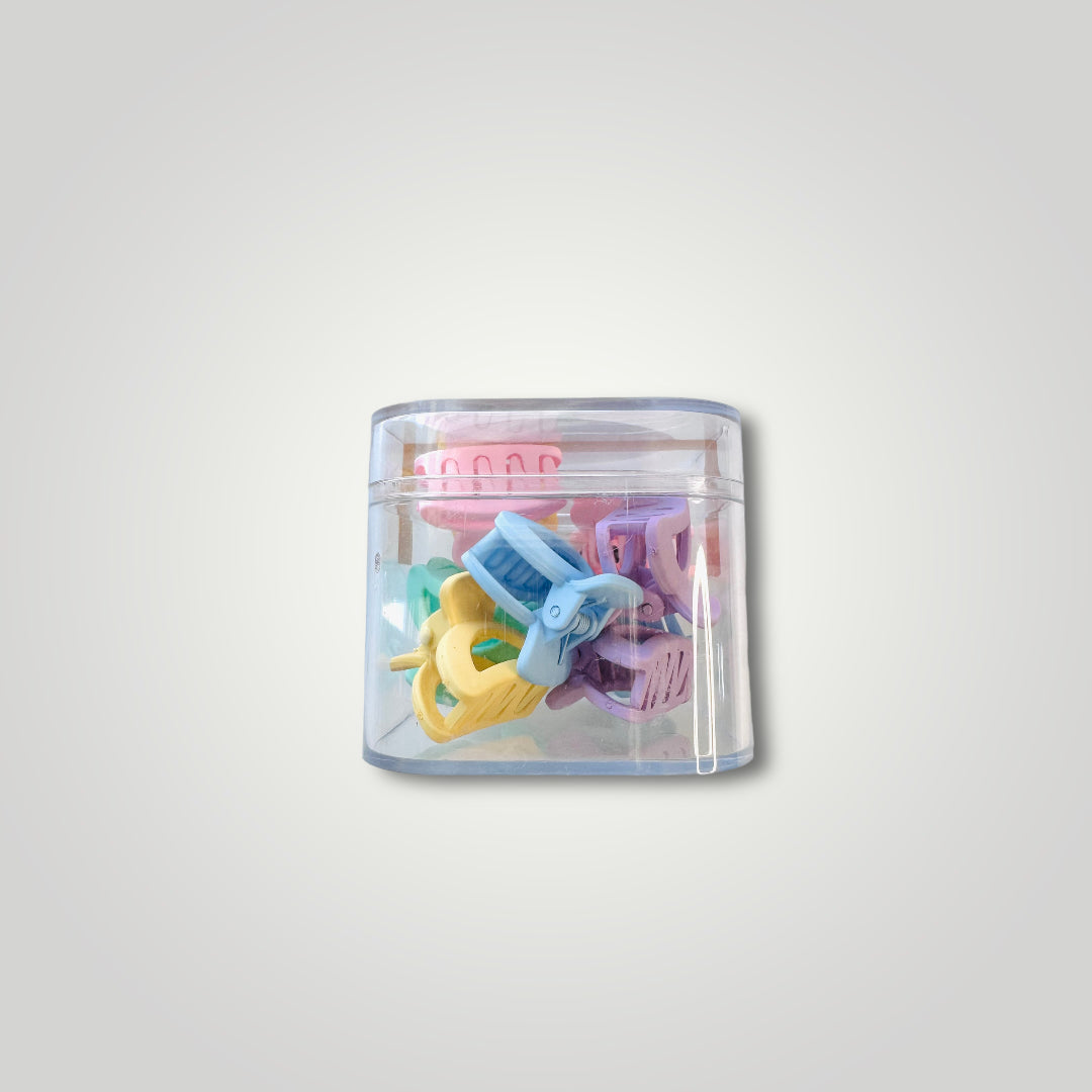 Small box filled with mini claw clips in different pastel colors; Yellow, Pink, Purple, Green and Blue.