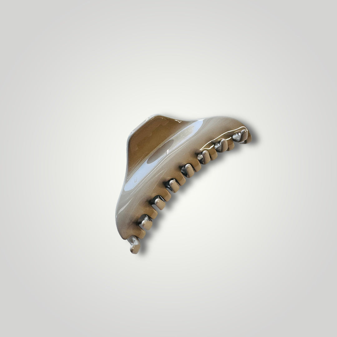 A sleek looking, light weight with strong grip acrylic claw clip. Color: Taupe.