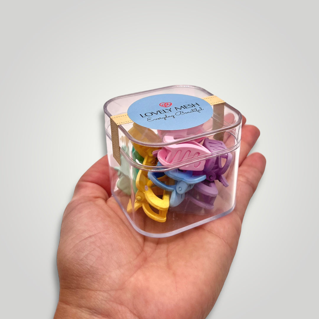 Small box filled with mini claw clips in different pastel colors; Yellow, Pink, Purple, Green and Blue.