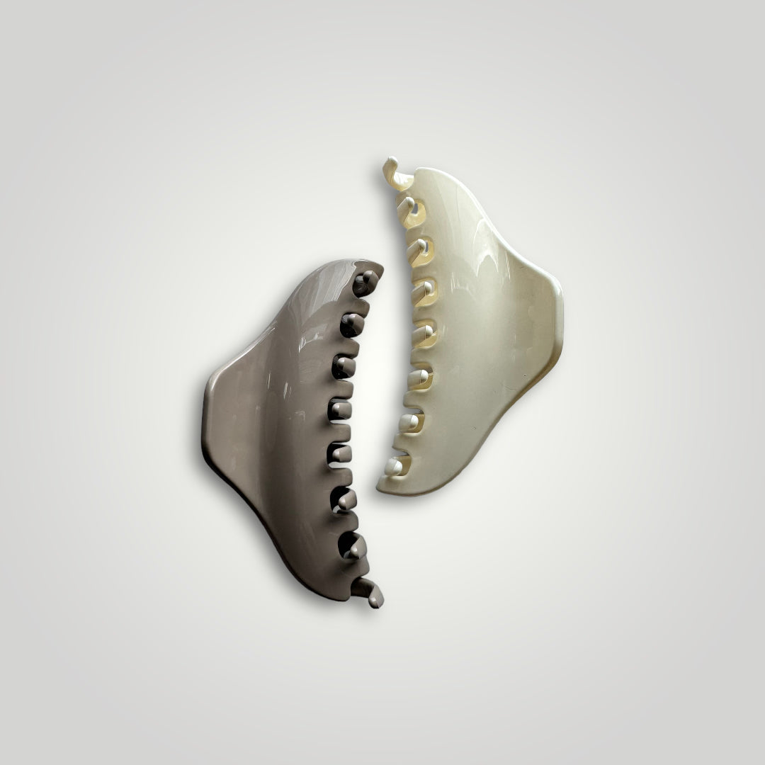A sleek looking, light weight with strong grip acrylic claw clip. Color: Off White.