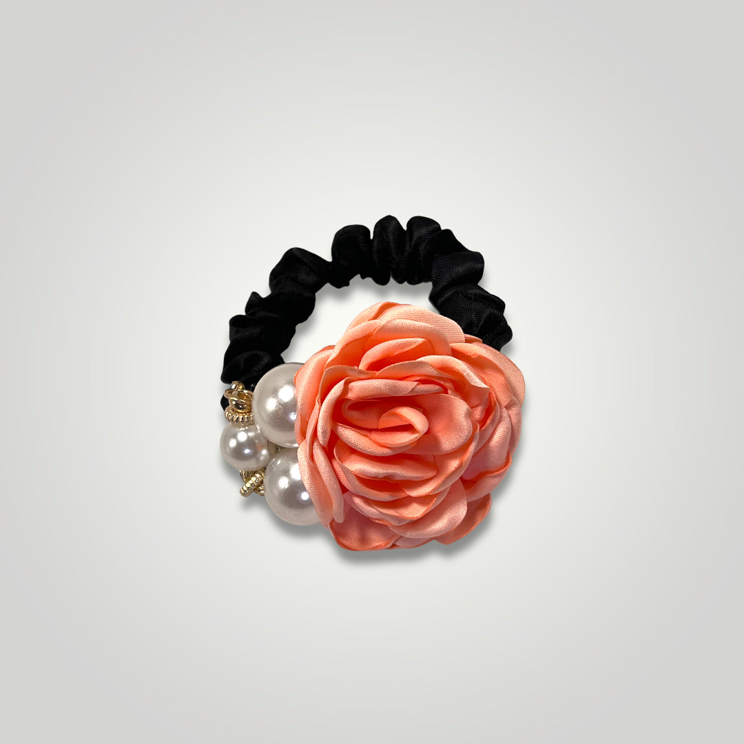 A thin black scrunchie with a peach rose and pearls.