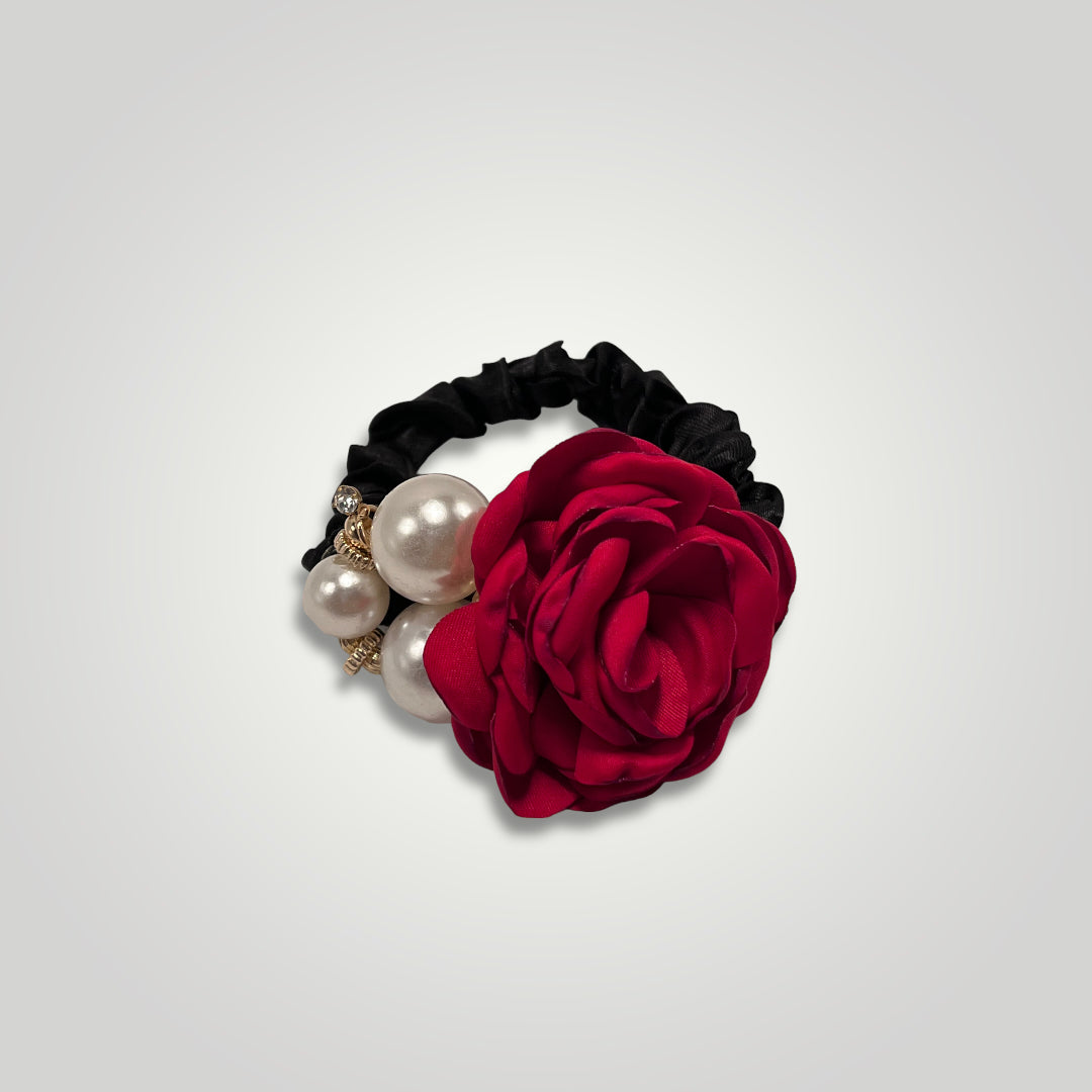 A thin black scrunchie with a red rose and pearls.