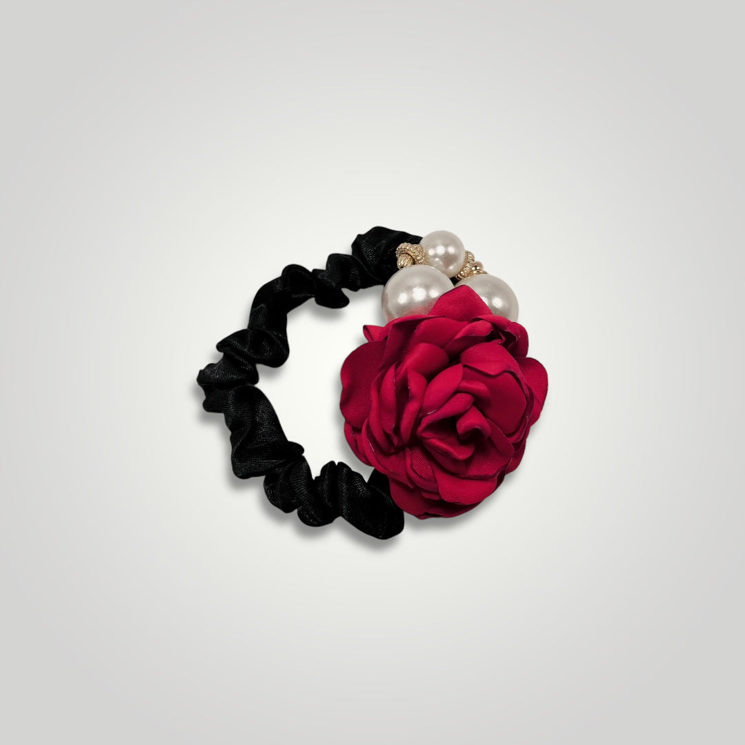 A thin black scrunchie with a red rose and pearls.