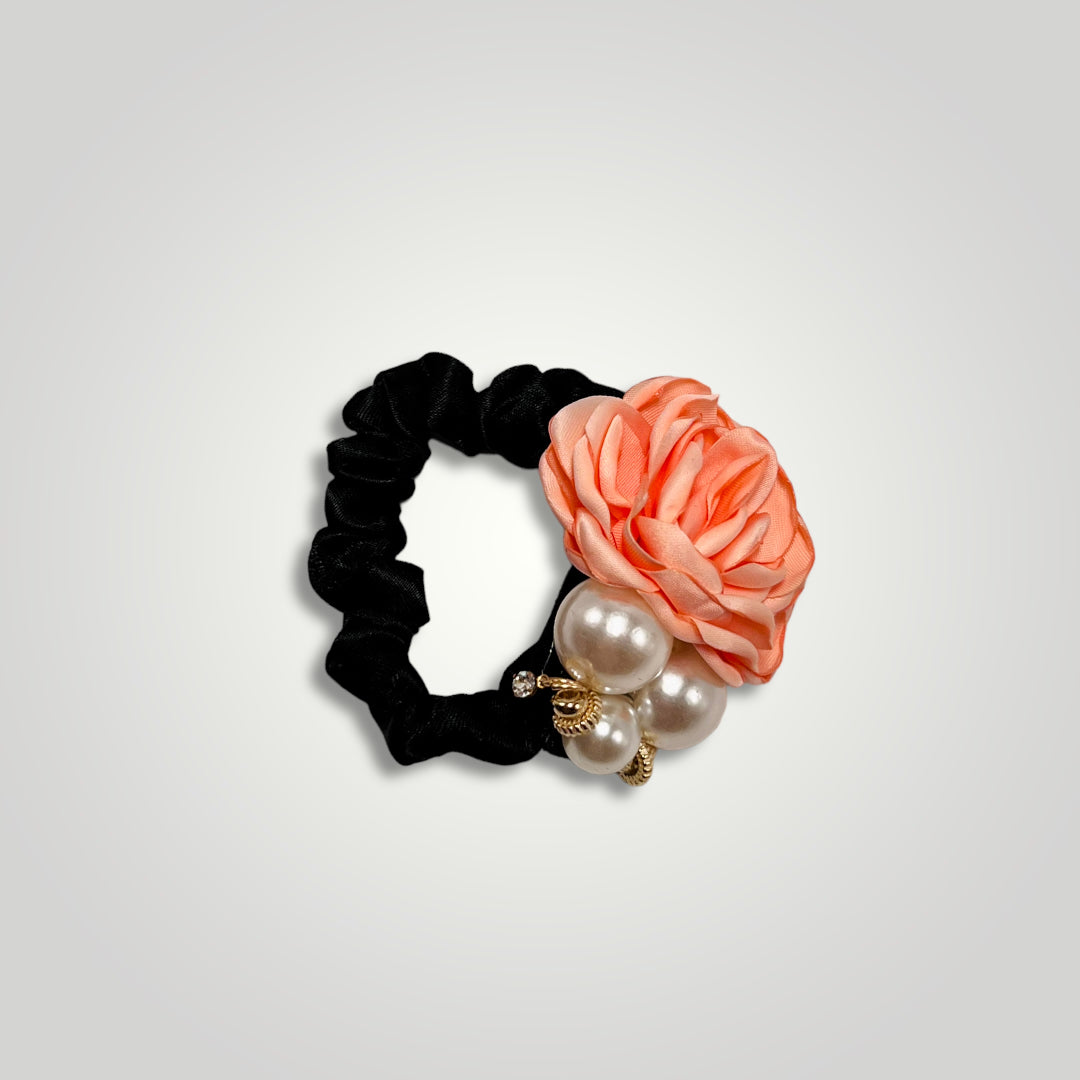 A thin black scrunchie with a peach rose and pearls.